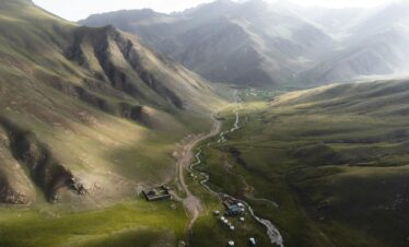 a view of a valley with mountains and a river