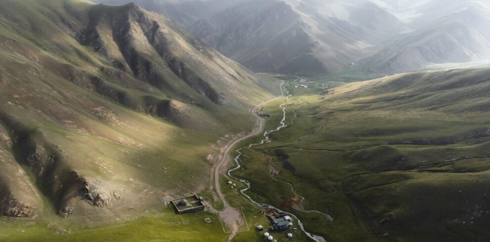 a view of a valley with mountains and a river